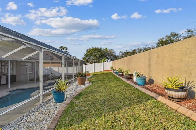 view of yard featuring a lanai, a patio area, a fenced backyard, and a fenced in pool