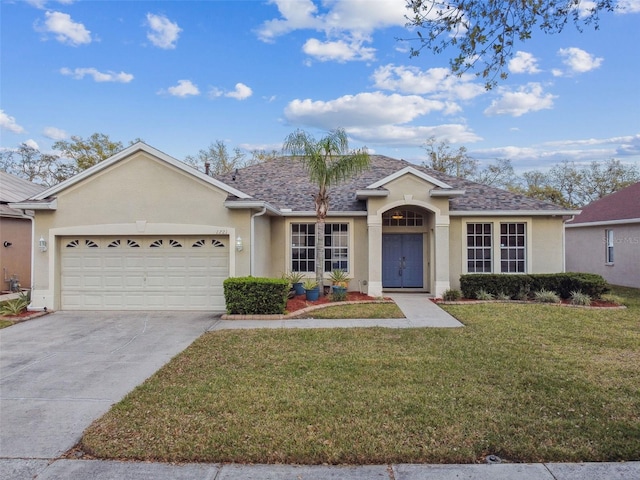 ranch-style home featuring a garage, concrete driveway, roof with shingles, stucco siding, and a front yard