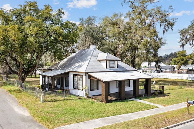 view of property exterior featuring a porch and a lawn