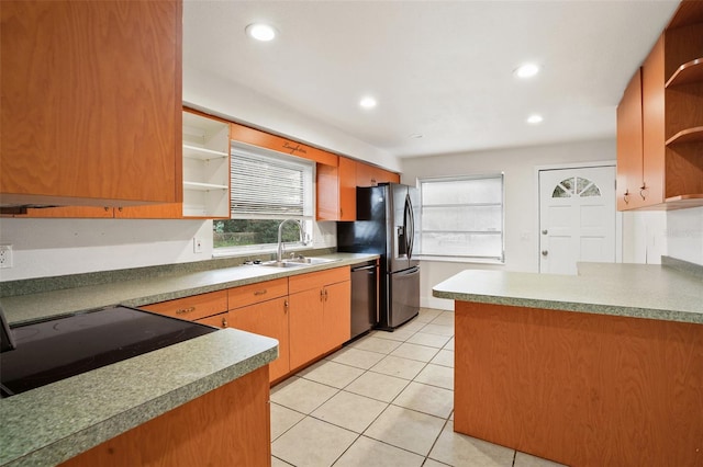 kitchen with sink, light tile patterned floors, and stainless steel appliances