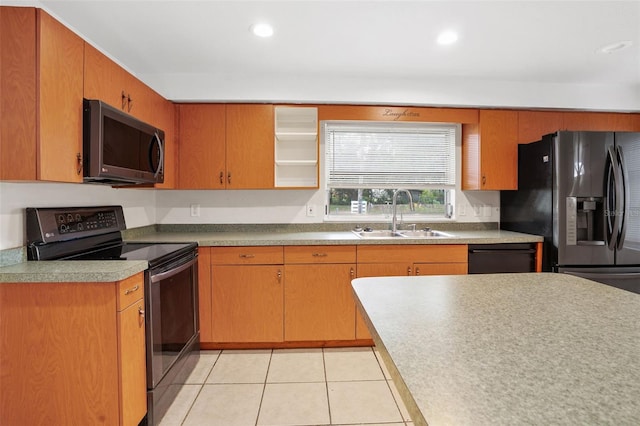 kitchen with light tile patterned flooring, sink, and black appliances