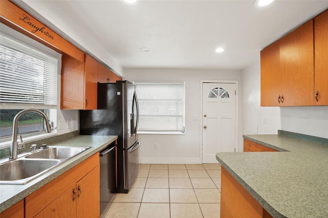 kitchen with sink, stainless steel dishwasher, and light tile patterned floors