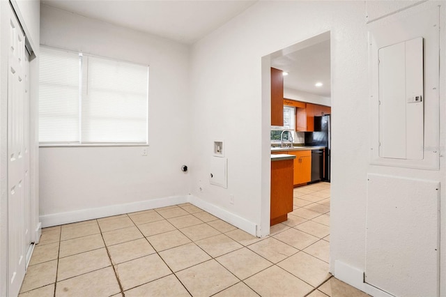 kitchen featuring dishwashing machine, electric panel, sink, and light tile patterned floors