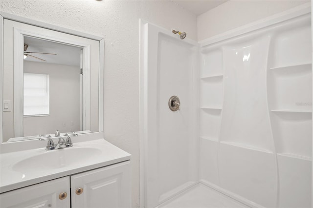 bathroom with a shower and vanity