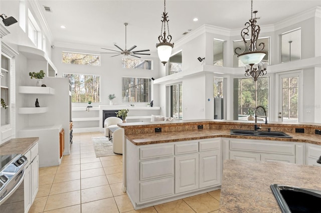 kitchen featuring white cabinetry, sink, ornamental molding, and electric stove