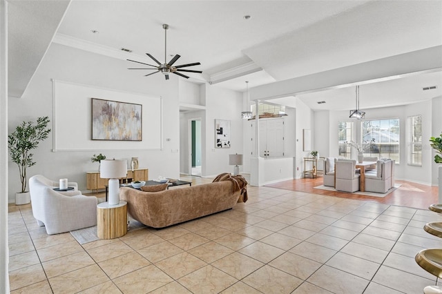 tiled living room featuring crown molding and ceiling fan