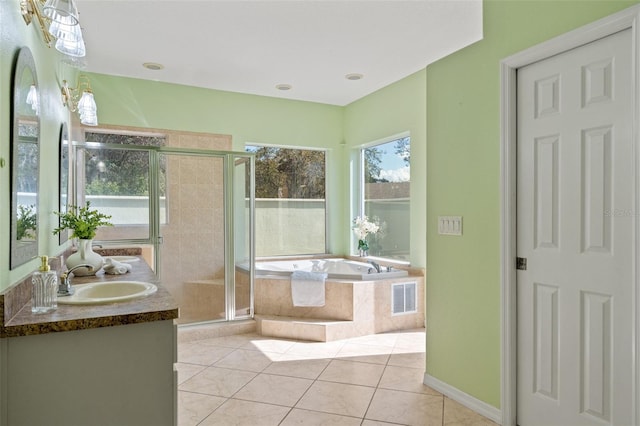 bathroom featuring tile patterned flooring, vanity, and plus walk in shower