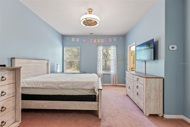 carpeted bedroom with a textured ceiling