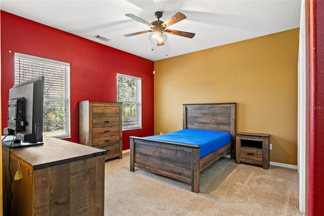 bedroom with light carpet and ceiling fan