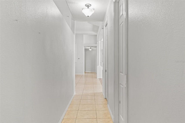 corridor with light tile patterned floors