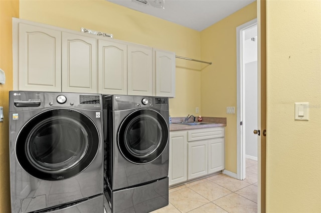 washroom with separate washer and dryer, sink, light tile patterned floors, and cabinets