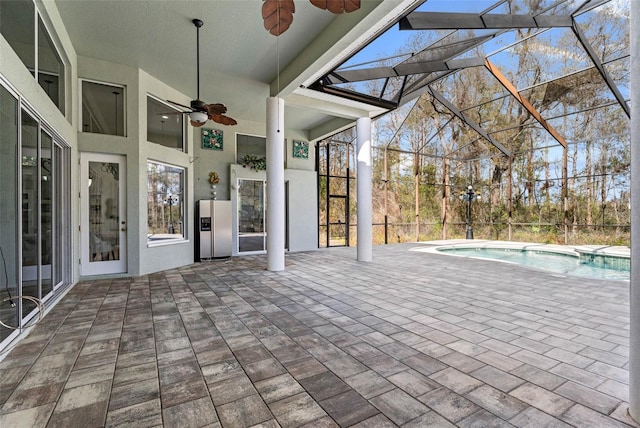 view of patio / terrace with ceiling fan and glass enclosure