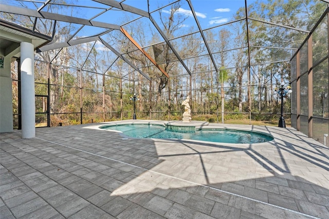 view of swimming pool with a lanai, a patio area, and a hot tub