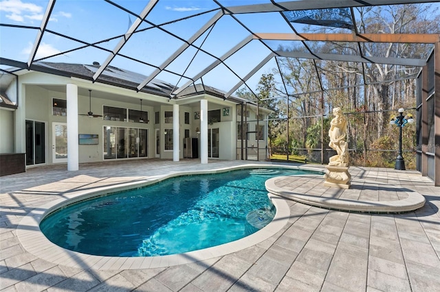 view of pool featuring ceiling fan, a lanai, and a patio area