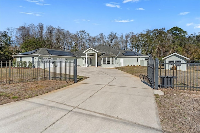 single story home with a garage, a front lawn, and solar panels