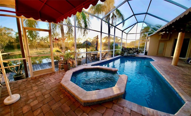 view of swimming pool with a lanai, a patio area, and a pool with connected hot tub