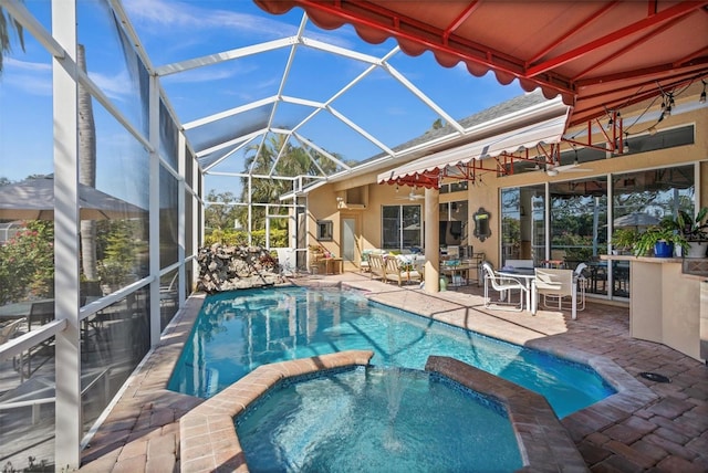 view of swimming pool with a lanai, a patio area, and a pool with connected hot tub