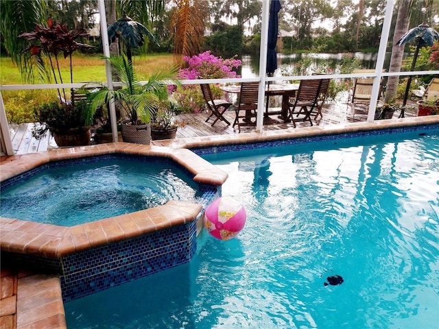 view of pool with a pool with connected hot tub