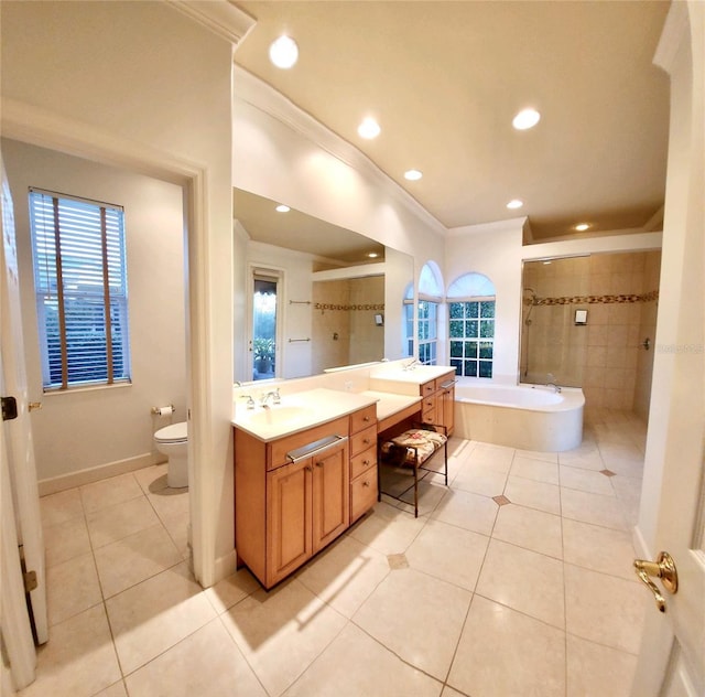 bathroom with toilet, a garden tub, tile patterned flooring, crown molding, and vanity