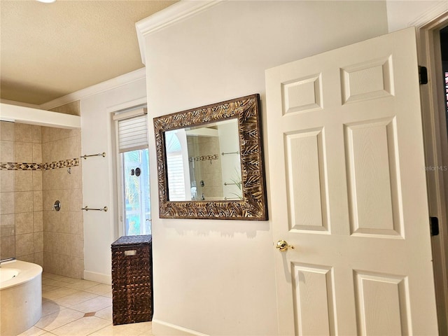 full bathroom featuring a textured ceiling, baseboards, ornamental molding, tile patterned floors, and walk in shower