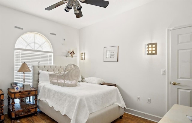 bedroom featuring visible vents, baseboards, ceiling fan, and dark wood-type flooring