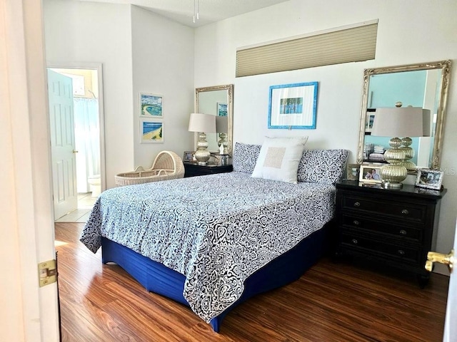 bedroom with dark wood-style flooring