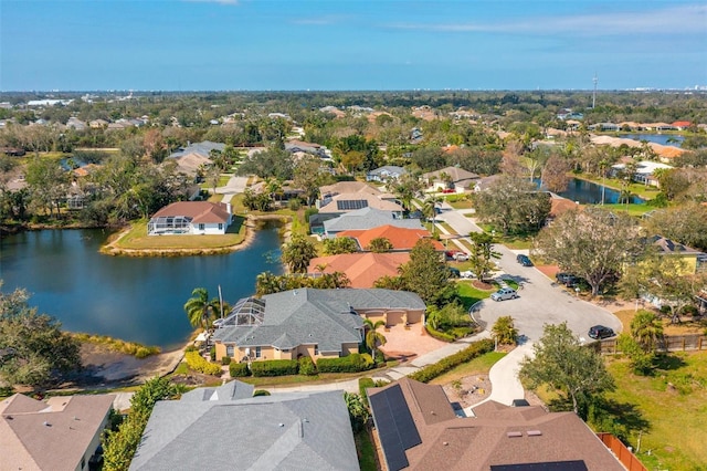 birds eye view of property with a water view and a residential view