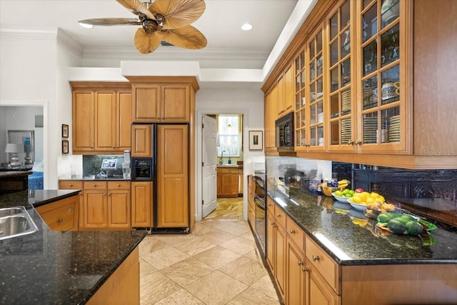 kitchen featuring brown cabinetry, glass insert cabinets, paneled refrigerator, crown molding, and black microwave