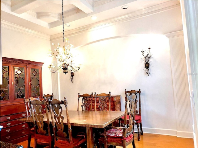 dining space featuring beamed ceiling, light wood-type flooring, an inviting chandelier, and crown molding