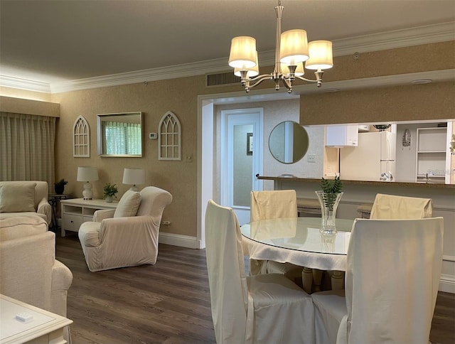 dining area with ornamental molding, a notable chandelier, and dark hardwood / wood-style flooring