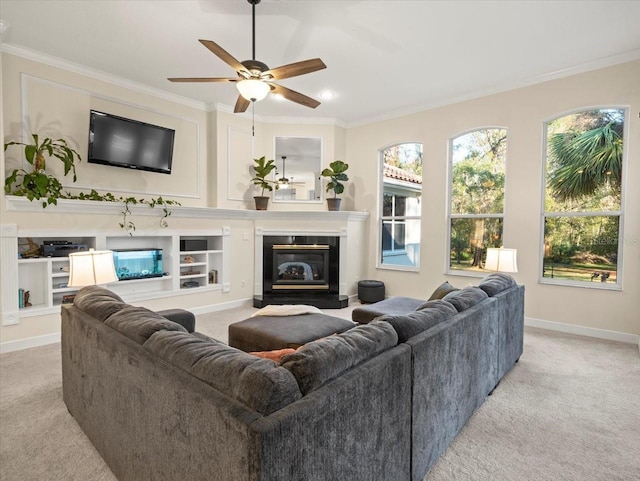 carpeted living room with ornamental molding and ceiling fan