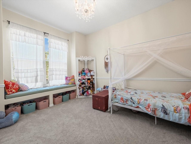 carpeted bedroom featuring a notable chandelier