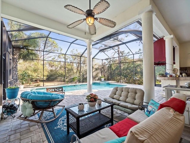 view of patio featuring a lanai, an outdoor hangout area, and ceiling fan