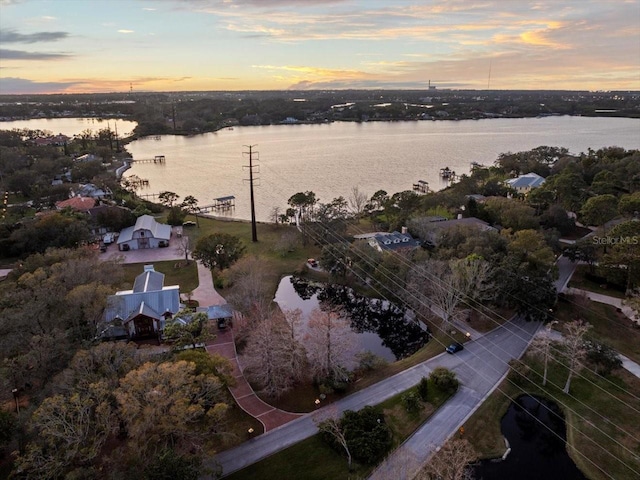 aerial view at dusk with a water view