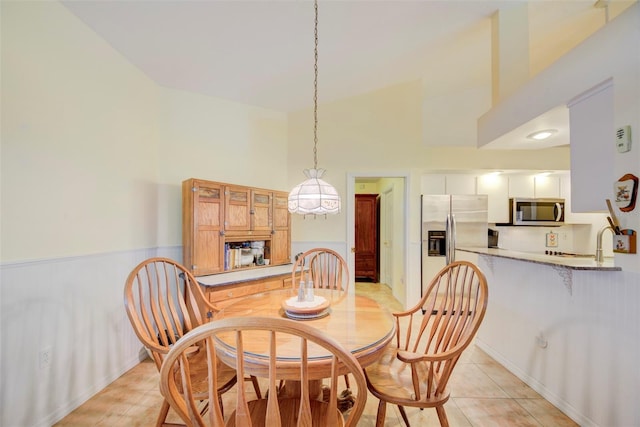 tiled dining room with a high ceiling