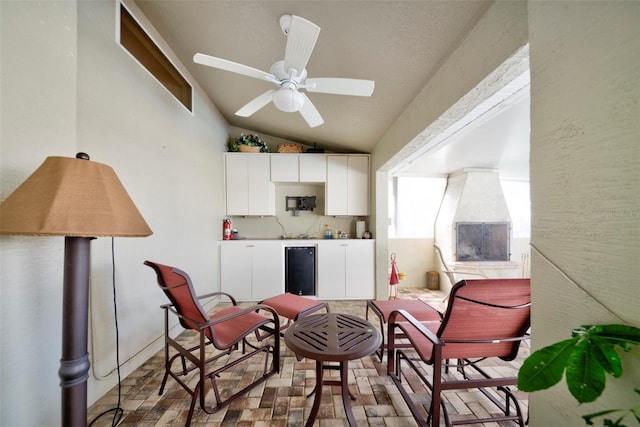 living area with lofted ceiling and ceiling fan