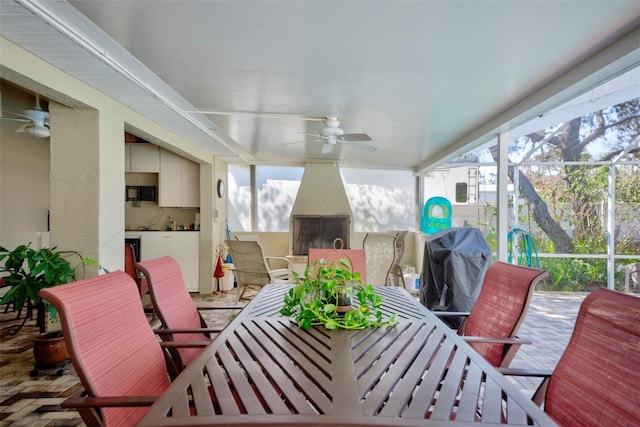 sunroom featuring ceiling fan