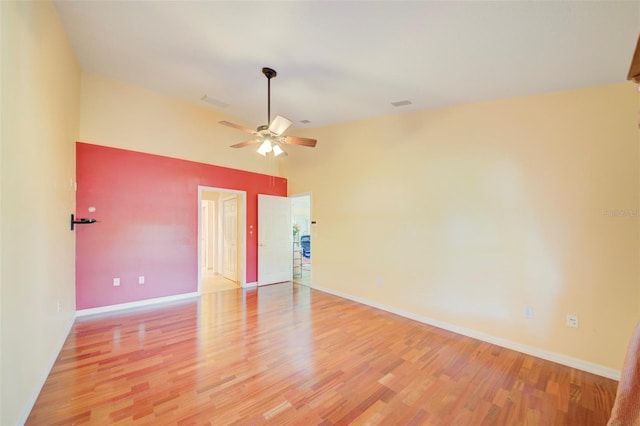 spare room with ceiling fan, high vaulted ceiling, and light wood-type flooring