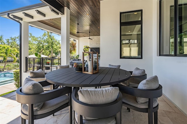 view of patio with a ceiling fan, an outdoor pool, and outdoor dining area