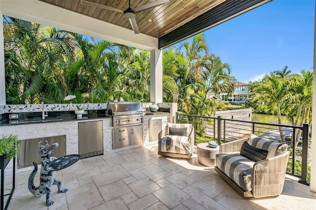 view of patio featuring grilling area, ceiling fan, a sink, and exterior kitchen