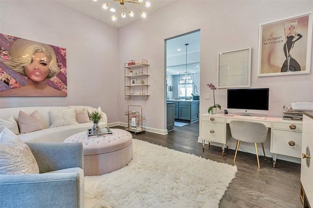 living area with a notable chandelier, baseboards, and dark wood-style floors
