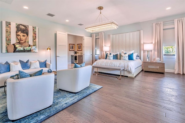 bedroom featuring baseboards, a chandelier, recessed lighting, visible vents, and wood-type flooring