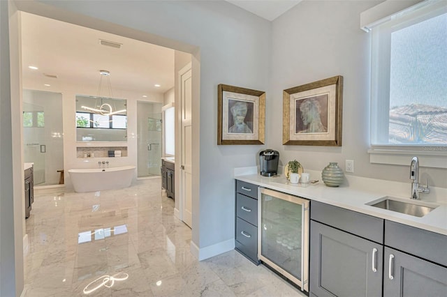 bar featuring visible vents, a sink, a healthy amount of sunlight, marble finish floor, and beverage cooler