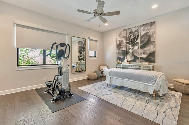 bedroom featuring wood finished floors, baseboards, and recessed lighting