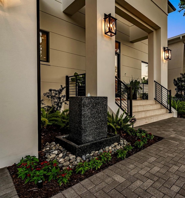 property entrance with stucco siding