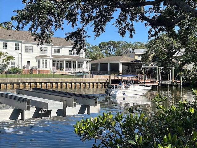 view of dock featuring fence and a water view