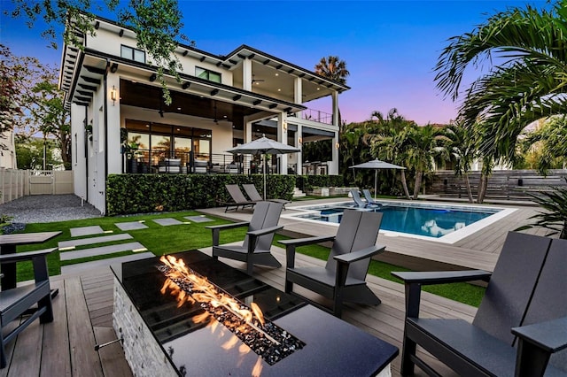 view of pool featuring a fenced in pool, a deck, fence, and an outdoor fire pit