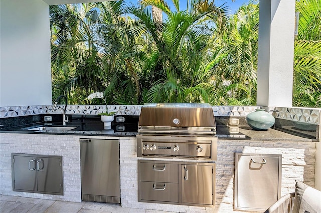 view of patio / terrace featuring exterior kitchen, a grill, and a sink