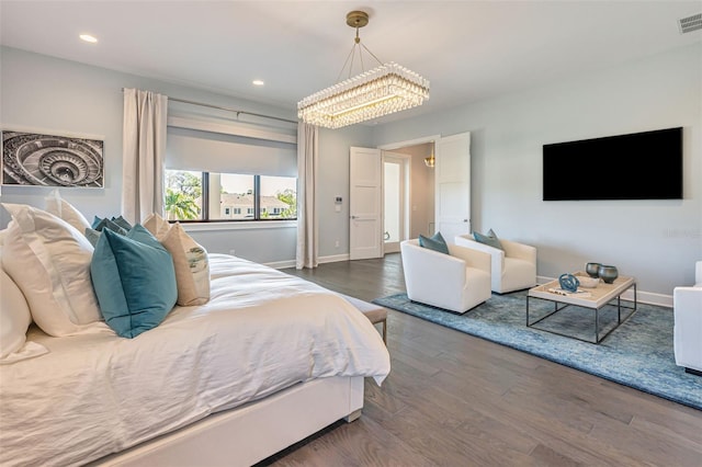 bedroom featuring visible vents, baseboards, a notable chandelier, recessed lighting, and wood finished floors