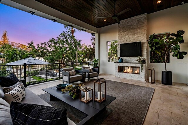 5004 S The Riviera, Tampa, FL 33609 - view of patio featuring a ceiling fan and an outdoor living space with a fireplace